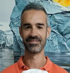 Artist Raul Alvarez in front of his painting