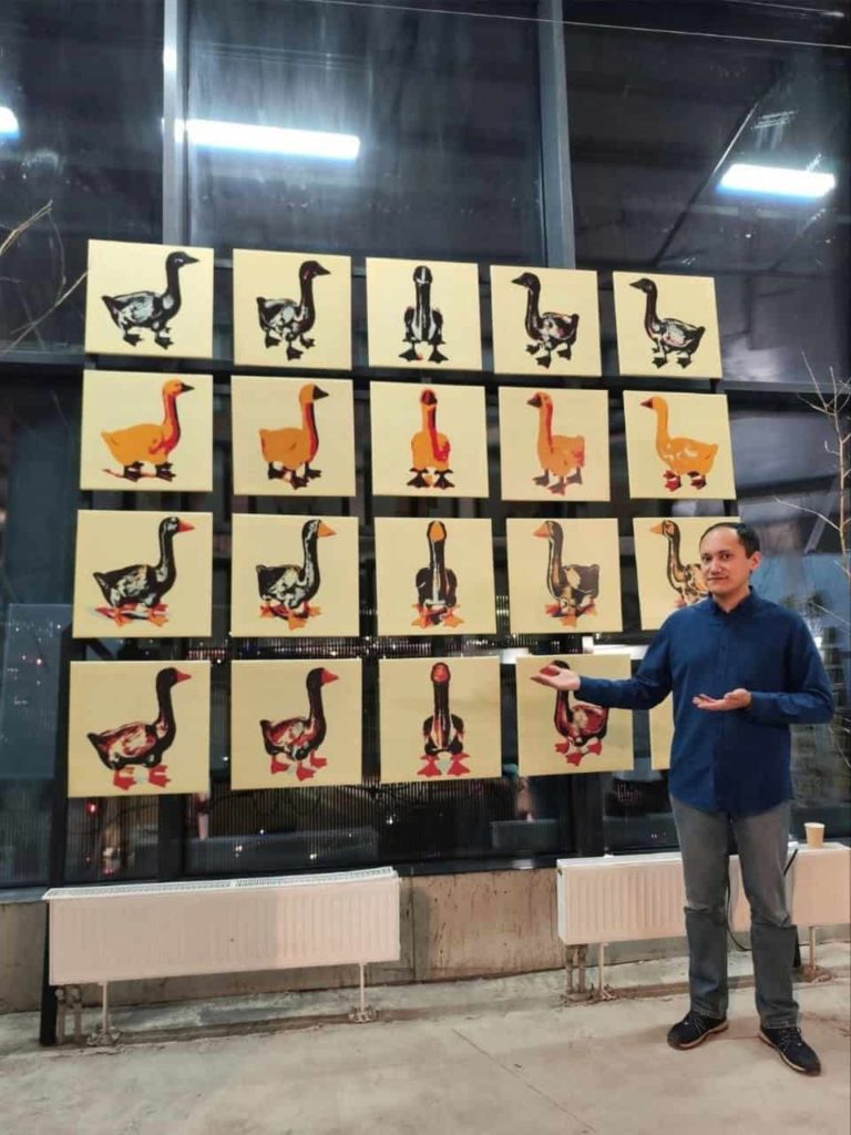 Artist Vasil Pixel with his series of paintings