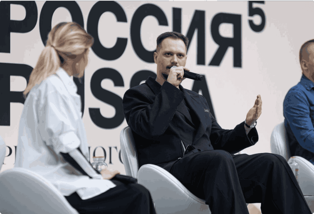 Digital artist Dima Shturm speaking on a panel at an art forum