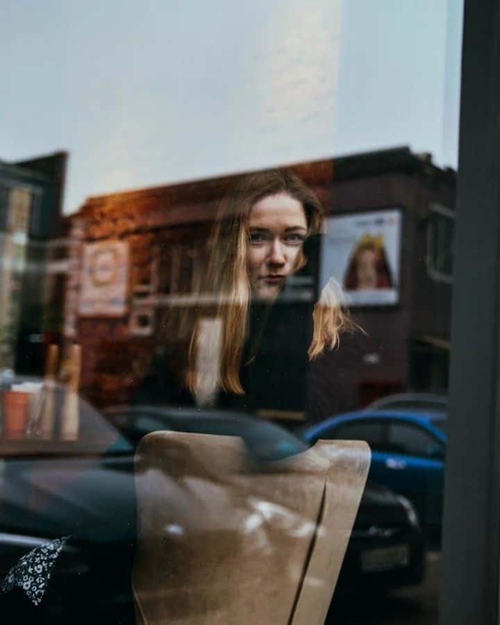 Artist reflected in a shop window