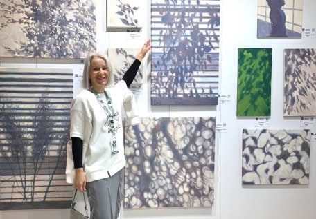 Artist at her stand of graphic works