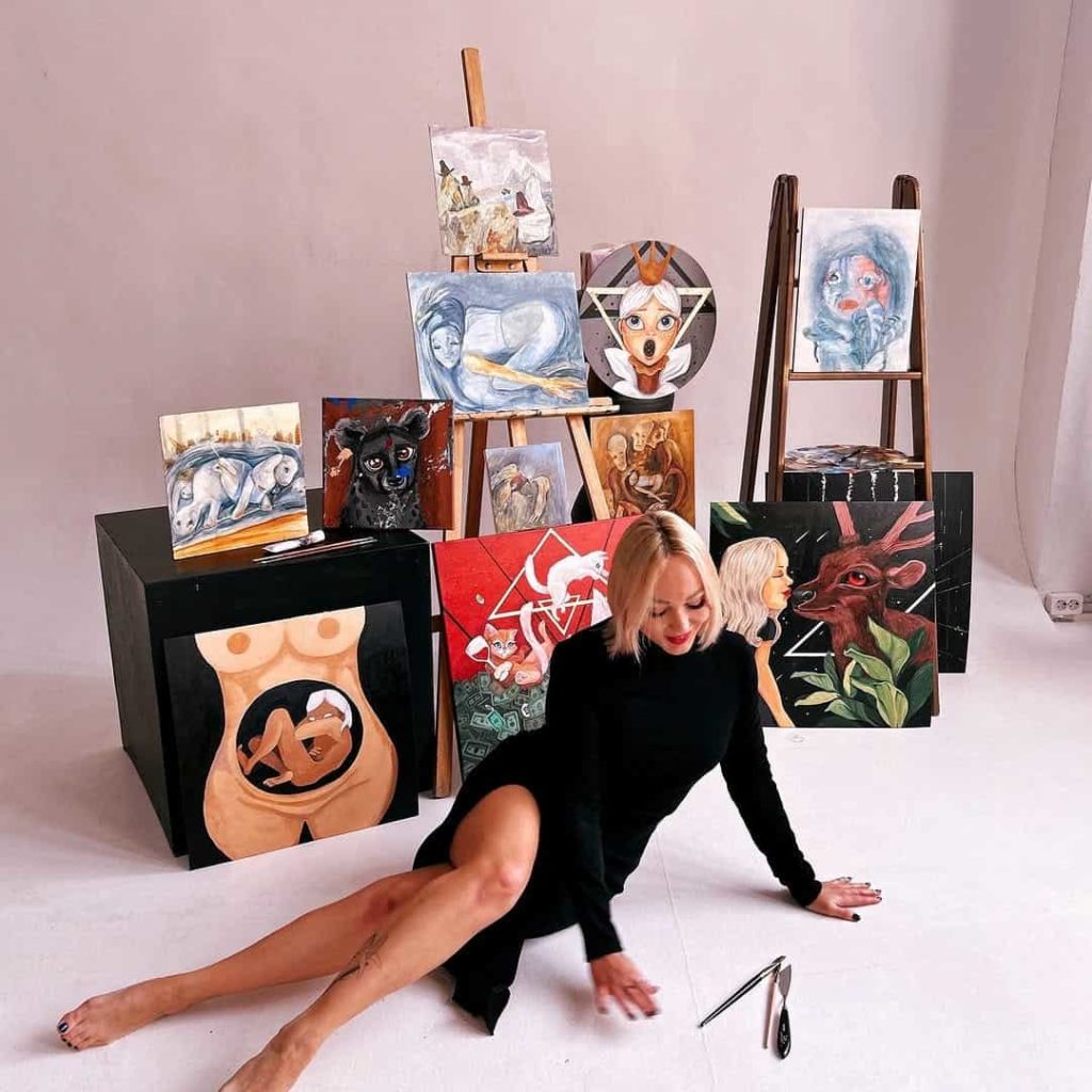 Artist with the paintings she made during a residency in Thailand