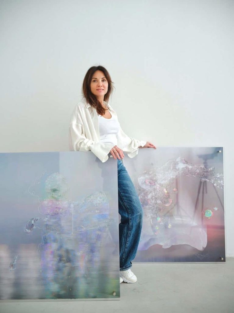 Artist beside her work combining traditional and digital media