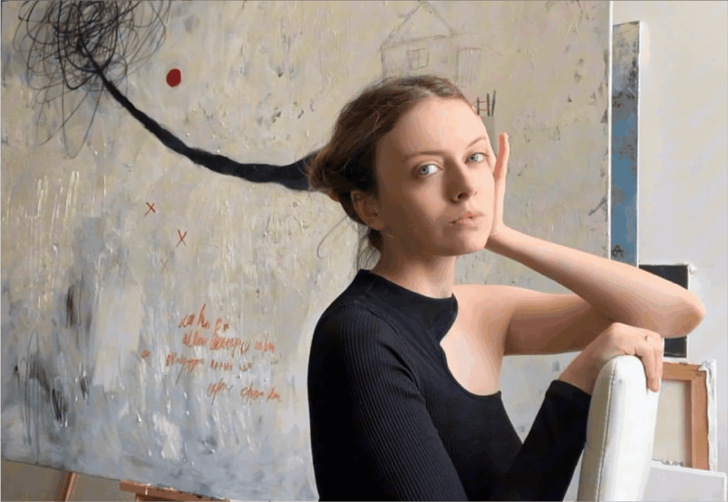 Artist Alina Aparina with her painting