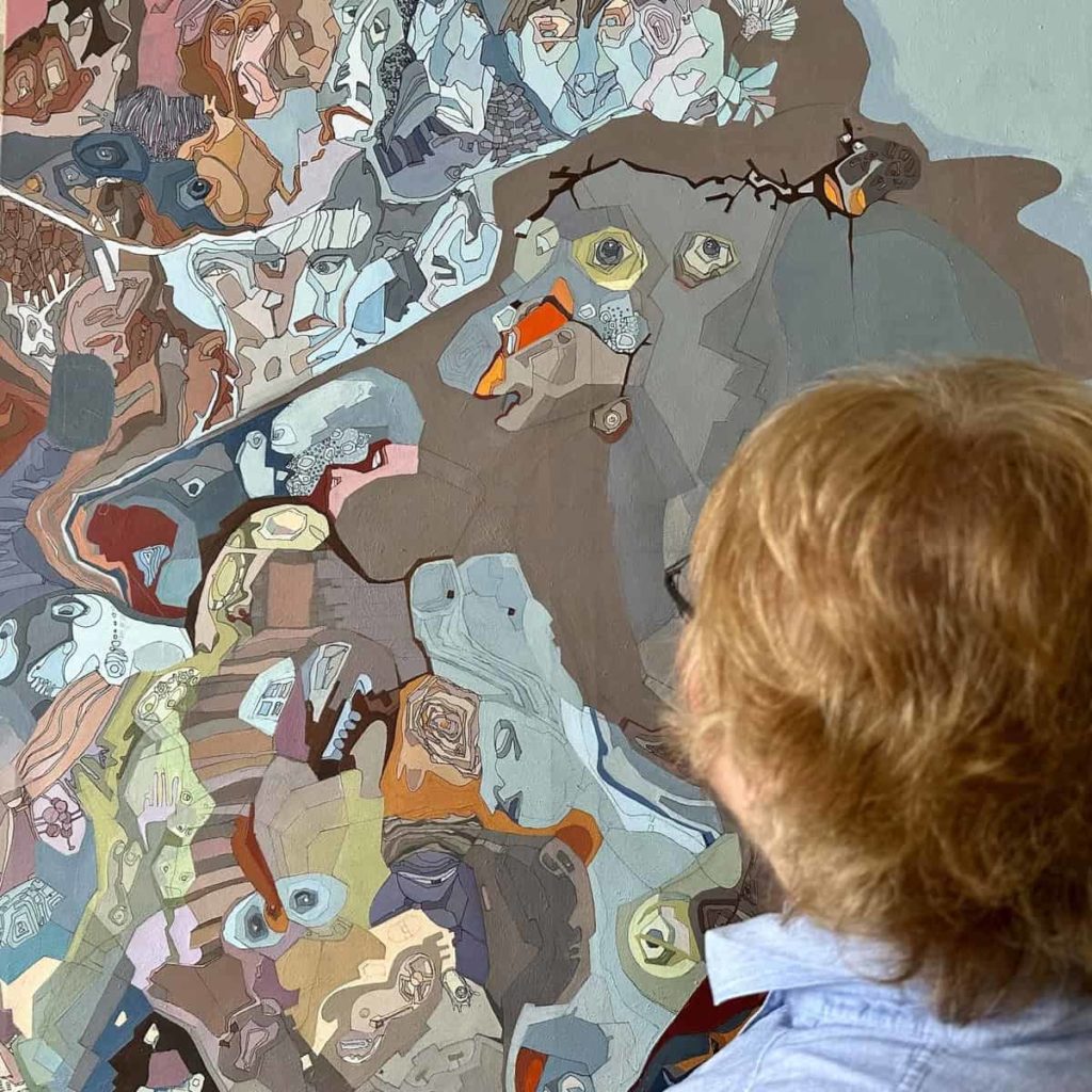 Viewer in front of a large work by Victoria Ark