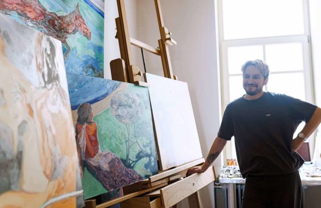 Artist at his easel in the studio