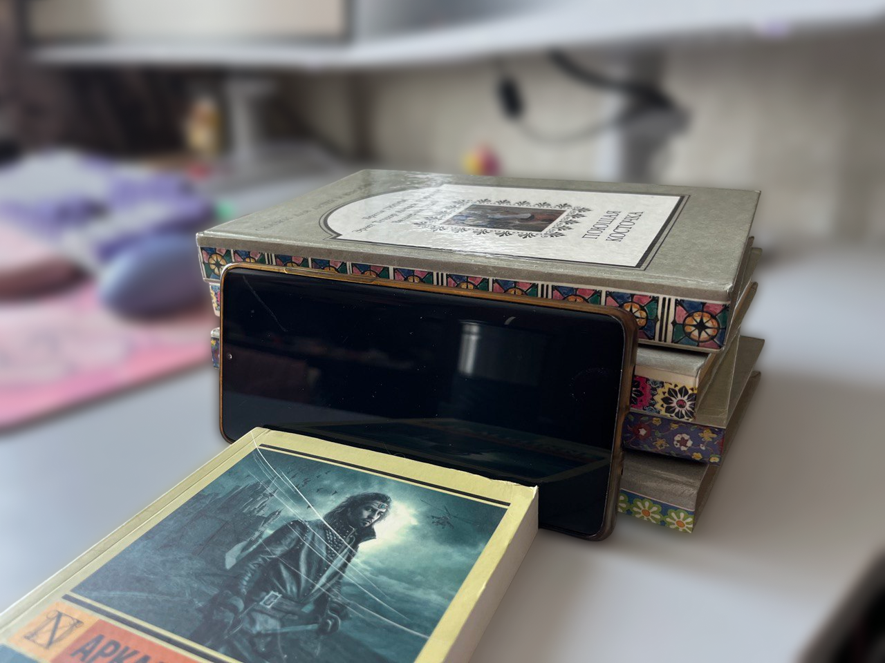 A phone on a stack of books